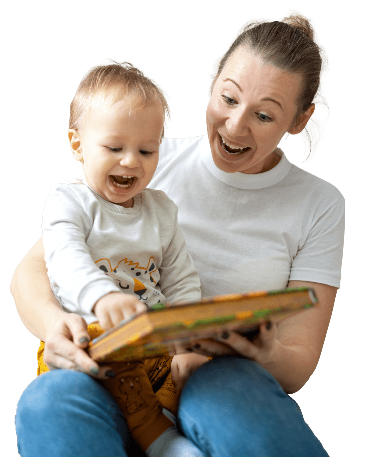A woman and a young child sitting together, looking at a colorful children's book with happy expressions.