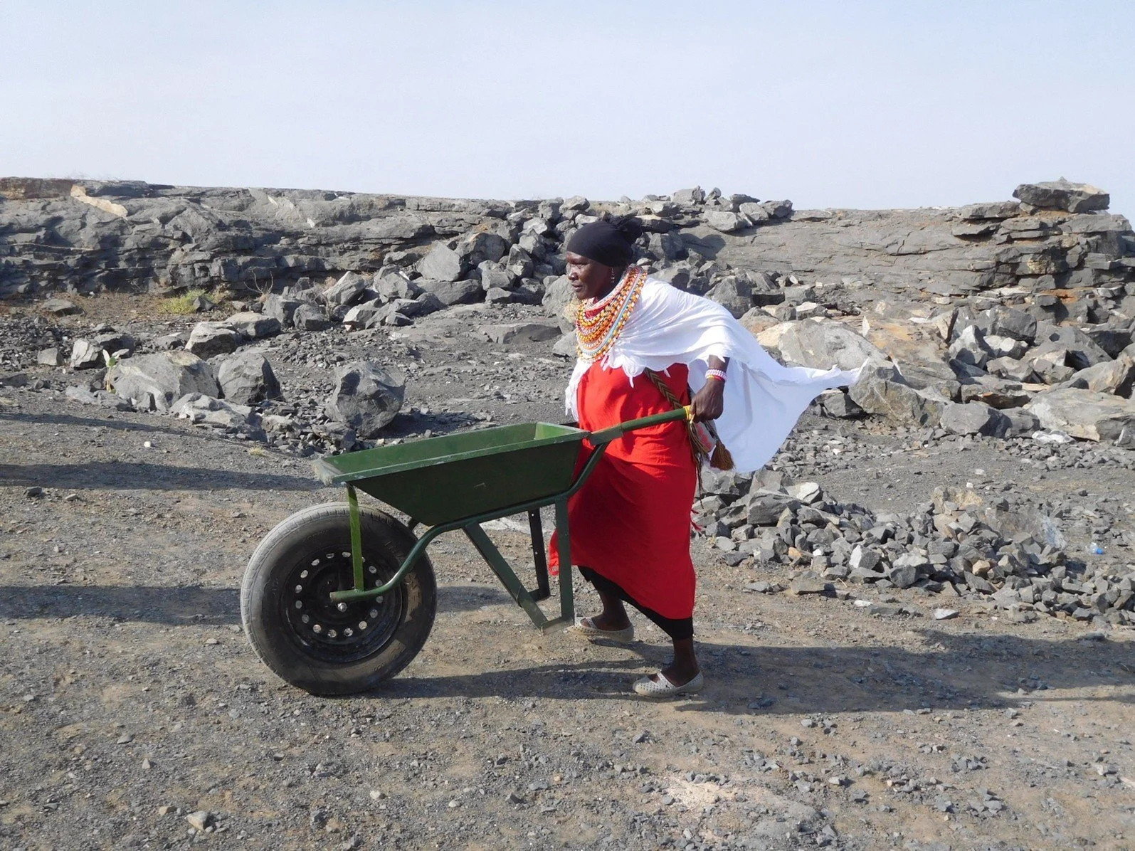 Alamash, Ltungai Village leader, hauls stones at the Ltungai Women’s Ballast Company (LWBC) rock quarry.
