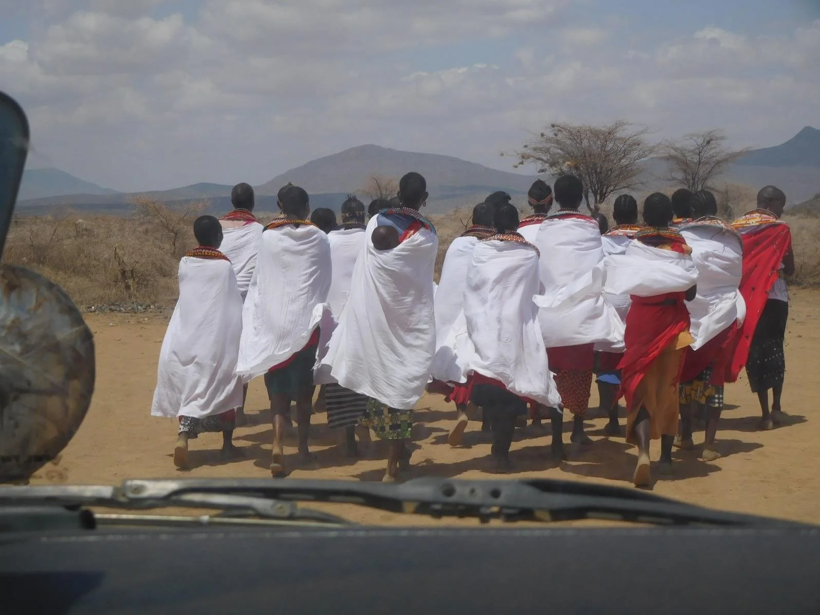 Ltungai women lead us into the village.