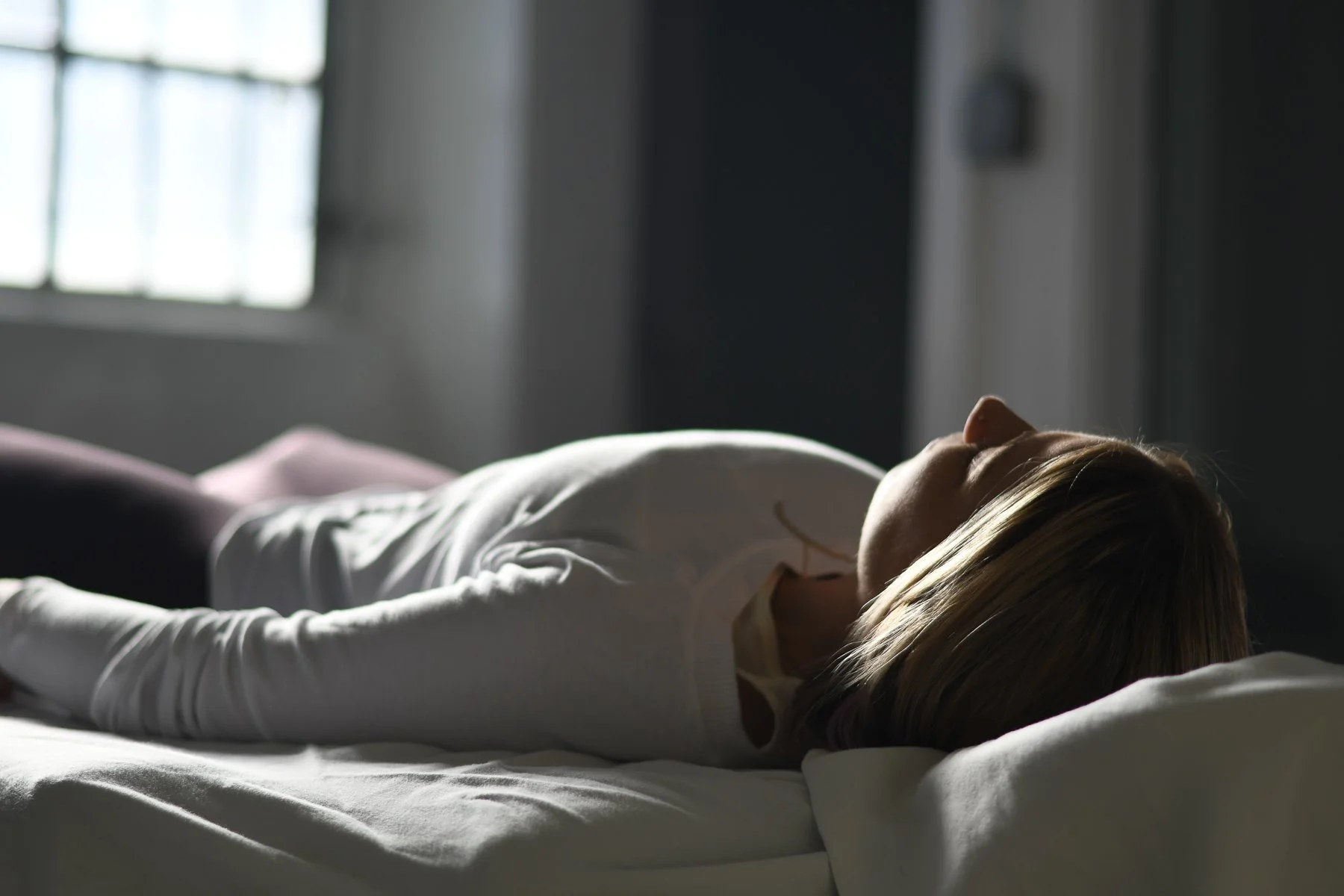 Woman lying on her back receiving Reiki