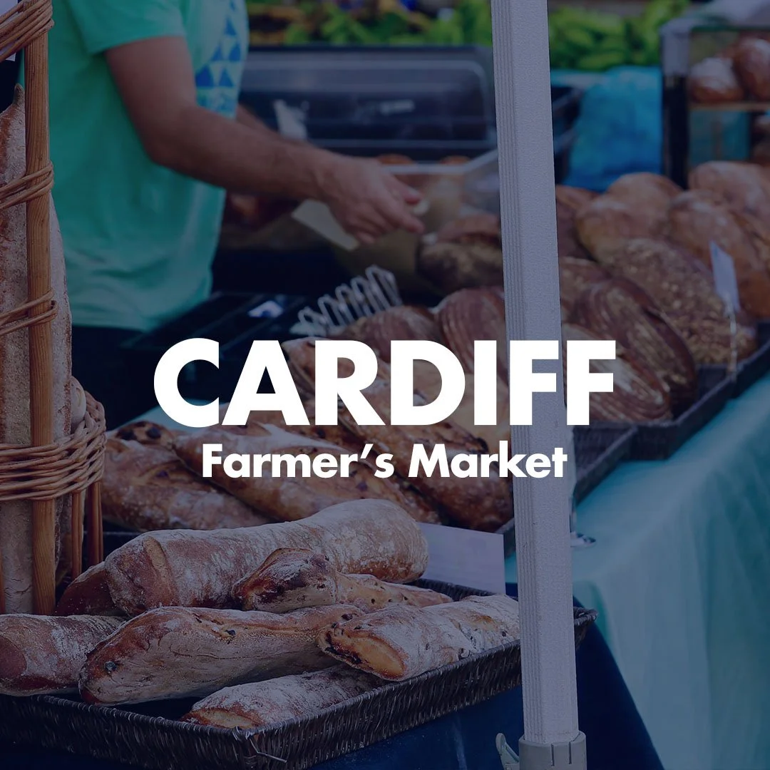 Fresh bread displayed at a farmer's market stall in Cardiff.