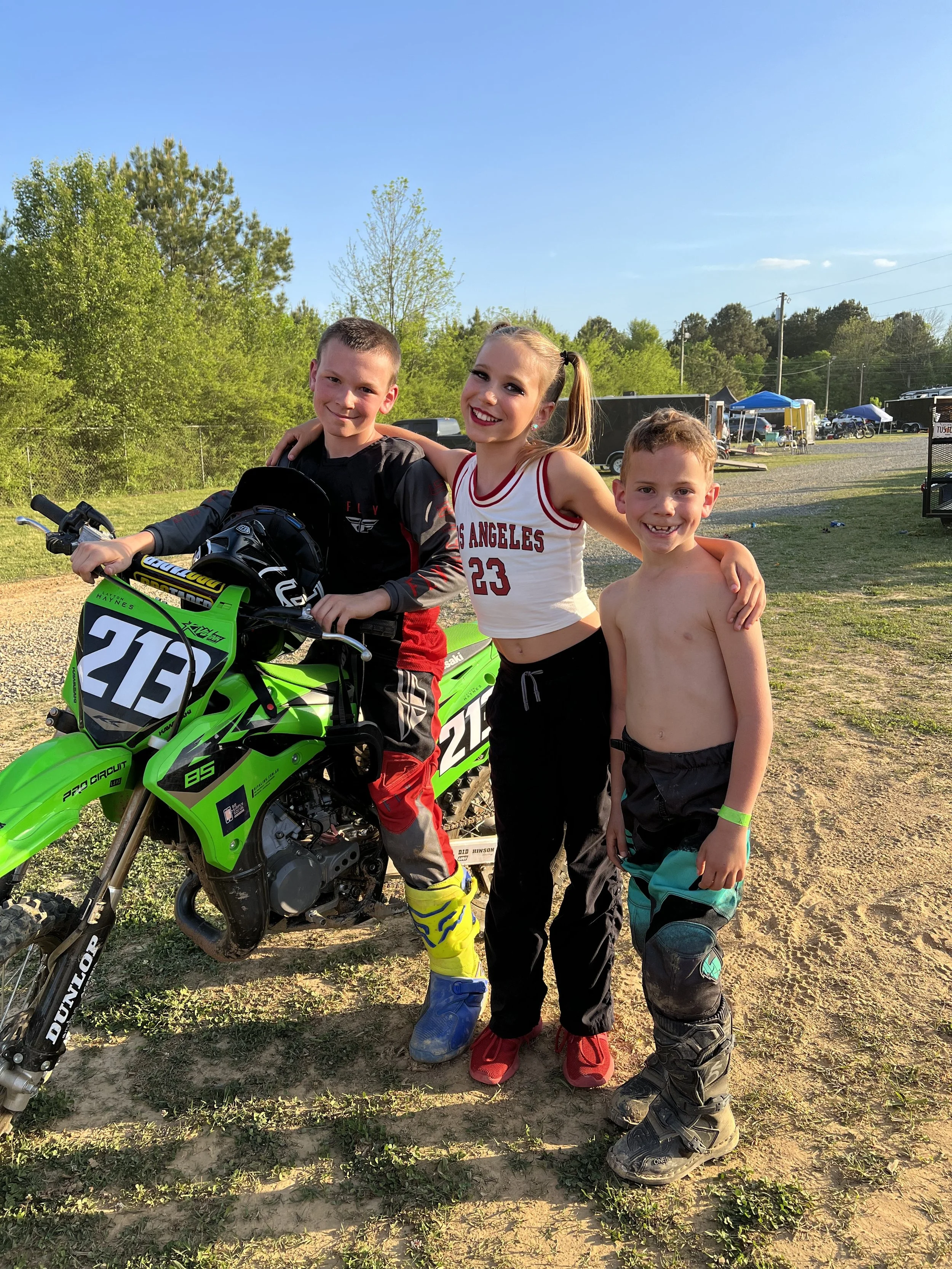 haynes 3 kids sitting on dirt bike