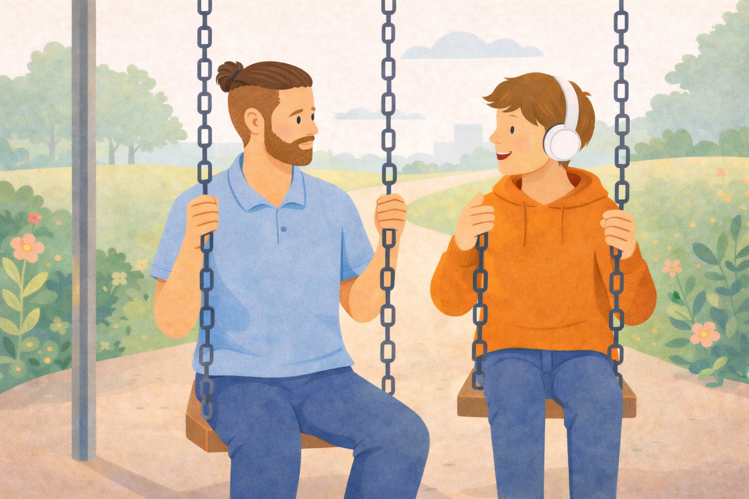 Two young men sitting on a swing set in a park. One has a beard and is wearing a blue shirt, while the other has headphones and is wearing an orange hoodie. They are talking and smiling at each other.