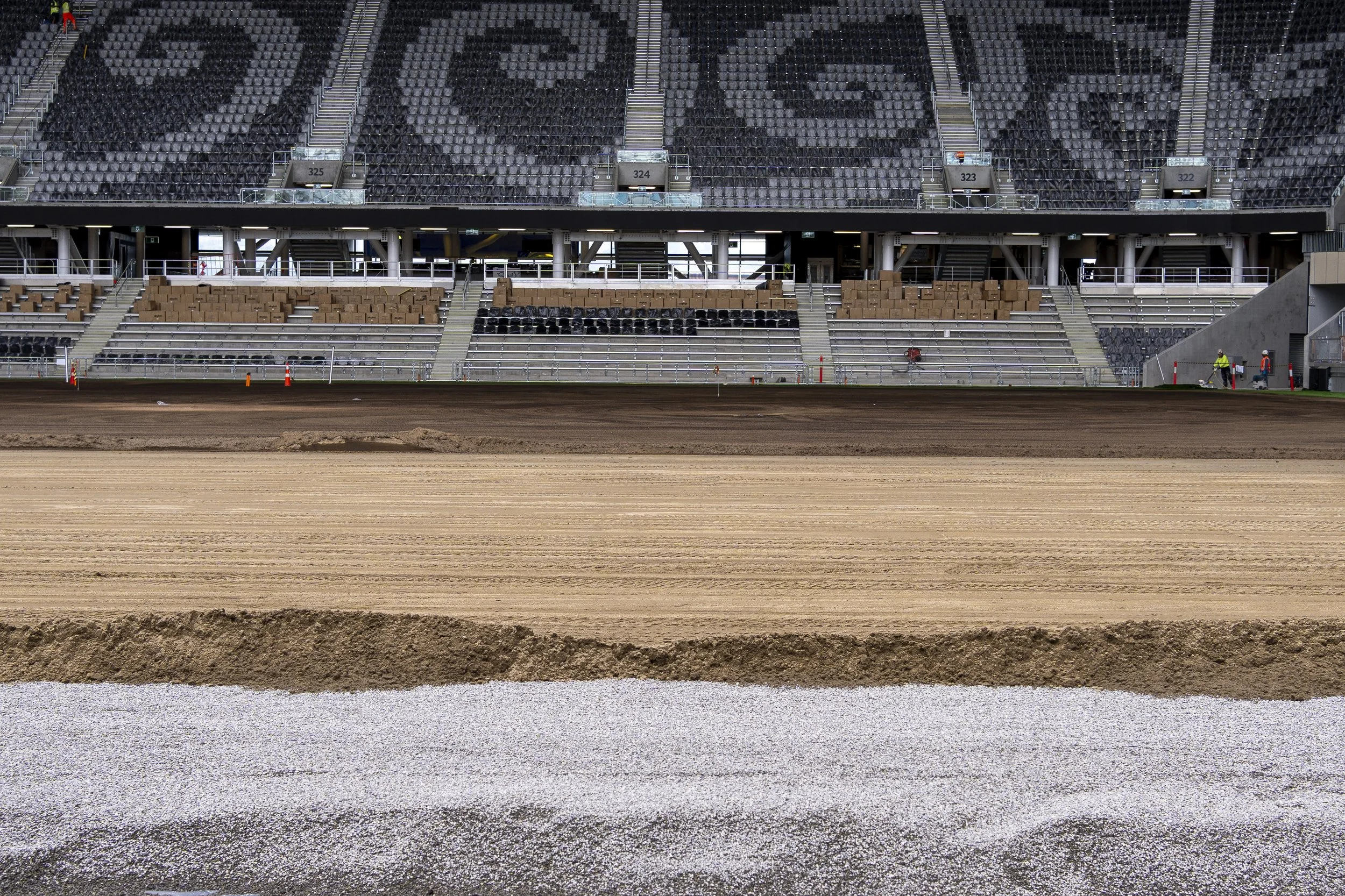 View of a stadium with empty rows of seats, Layers of specility mix supplied into One Stadium New Zealand for the playing turf