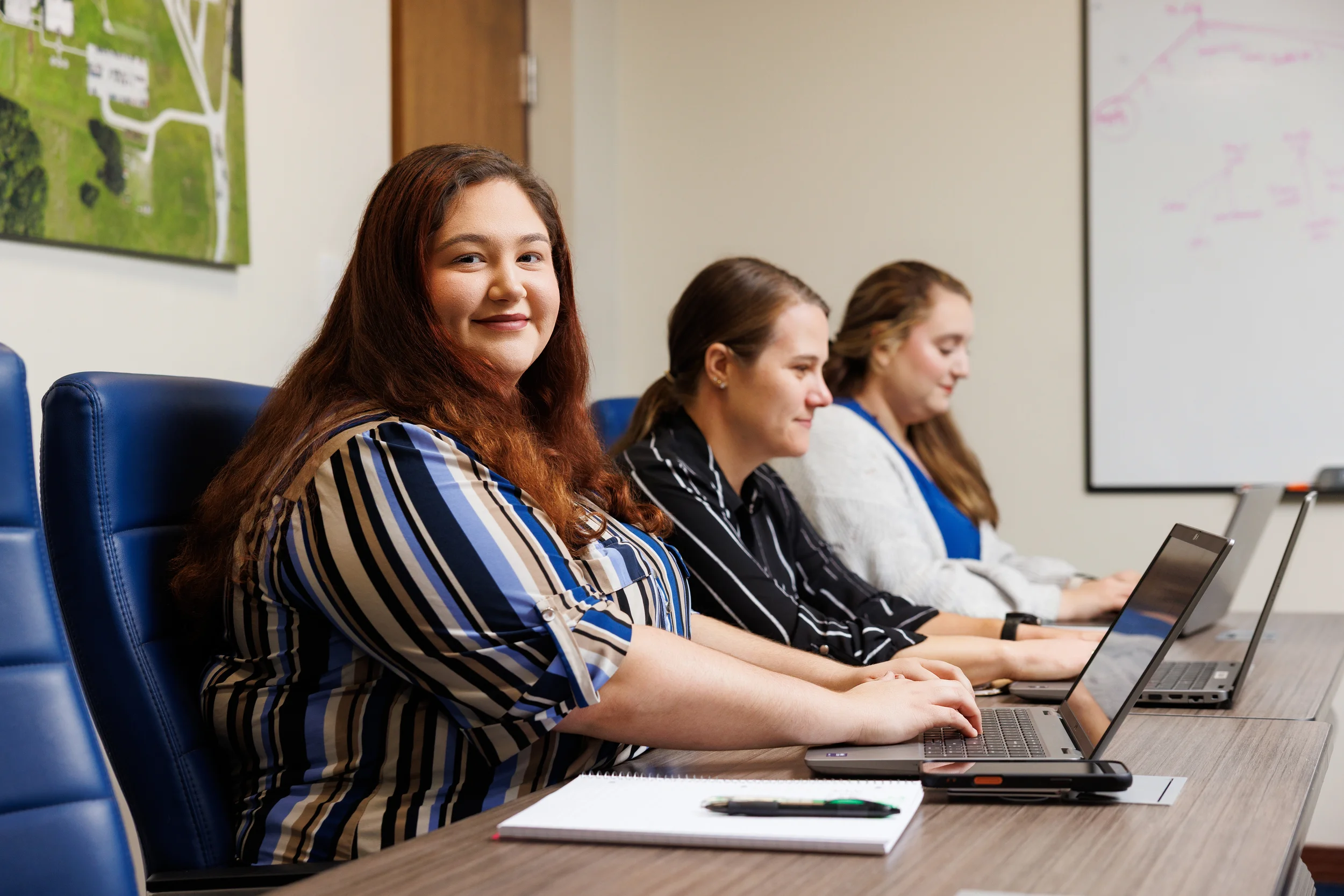 Image of three women in human resources at a meeting
