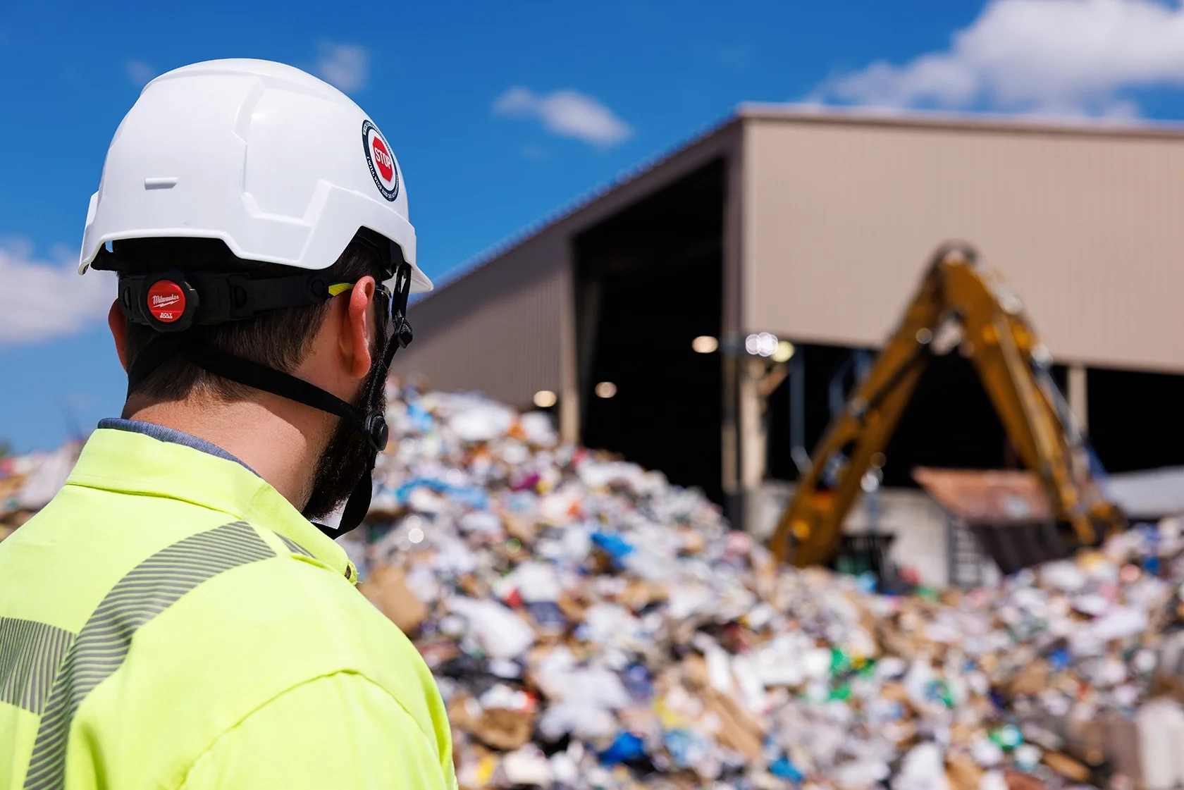 Image of a male in safety gear looking over environmental materials