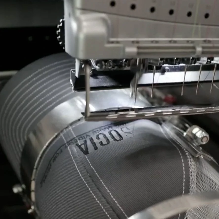 Close-up of commercial embroidery machine stitching a hat.