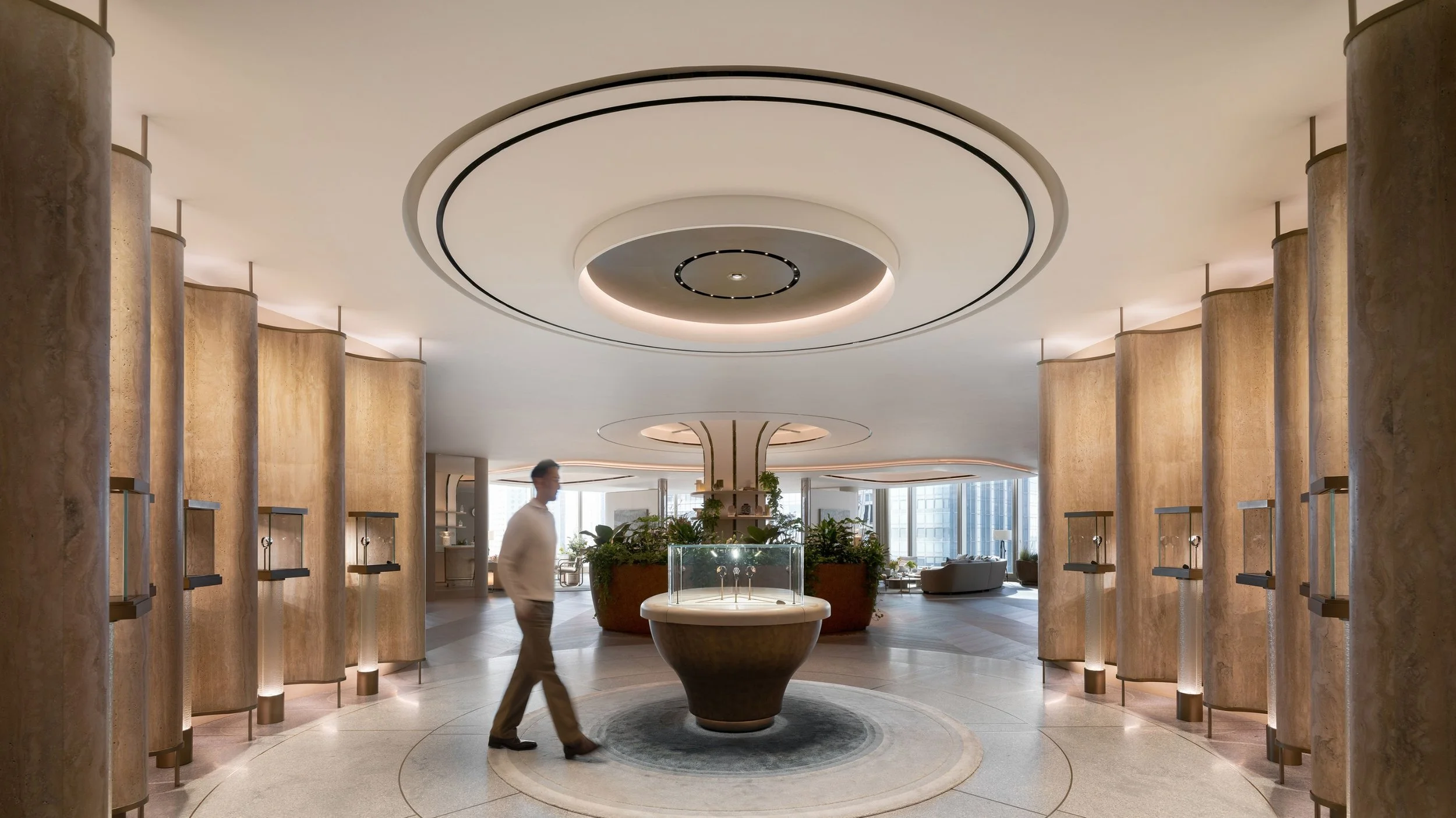 Main gallery inside the Audemars Piguet House in Hong Kong at The Henderson, showcasing circular architecture, illuminated watch displays, and a welcoming residential atmosphere.