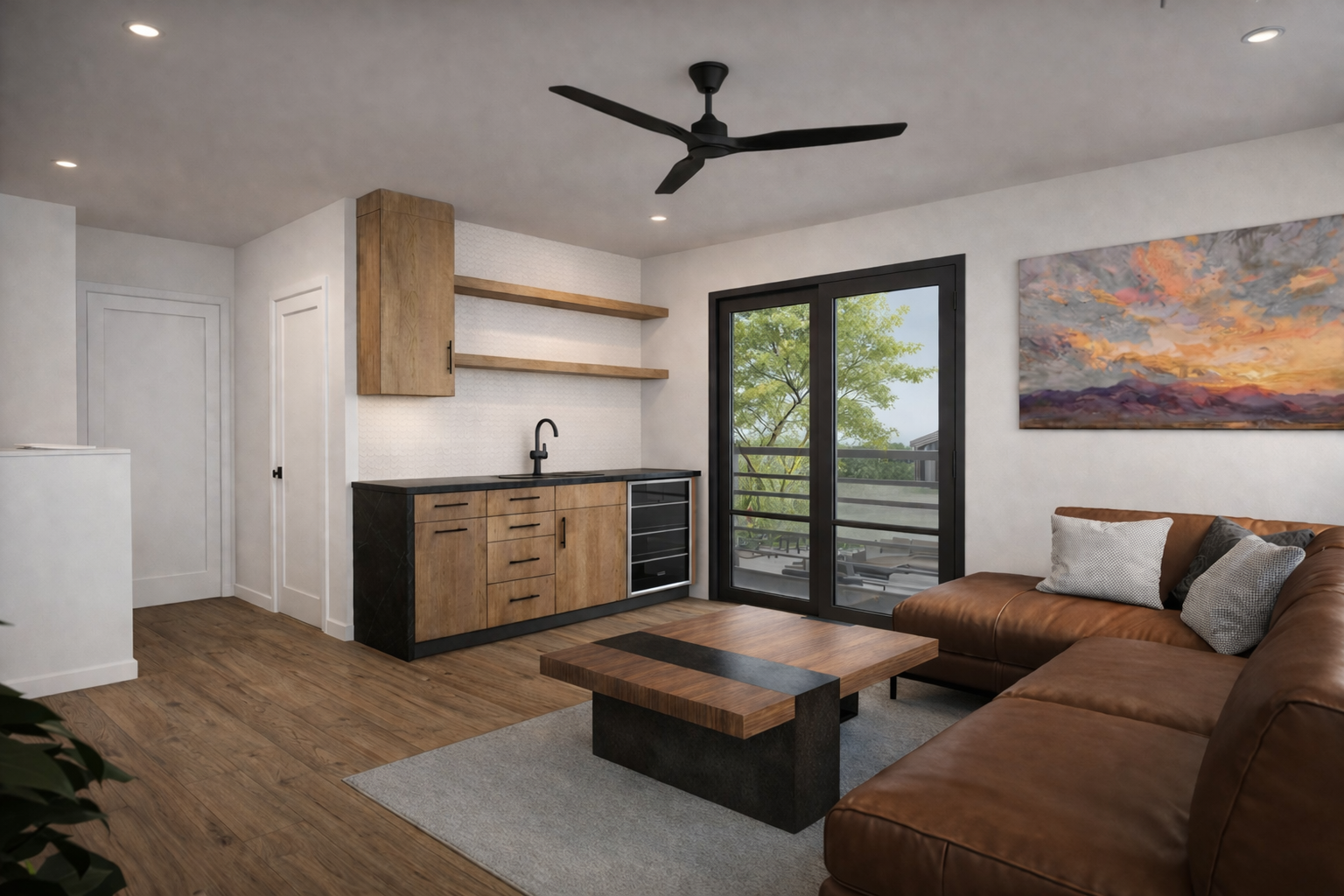 Living room with brown leather sofa, wooden coffee table, wall art, sliding glass door to balcony, kitchenette with wooden cabinets and black countertop, open shelves, ceiling fan, and hardwood flooring.