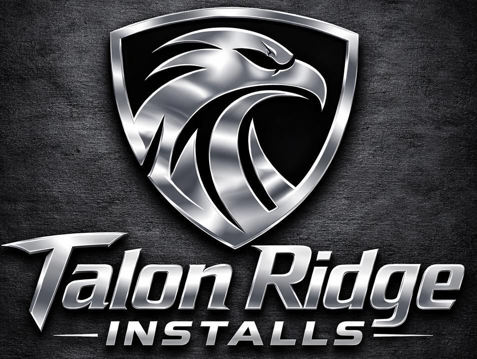 A metallic logo of a stylized eagle's head inside a shield, with the text "Talon Ridge Install" below, set against a black textured background.