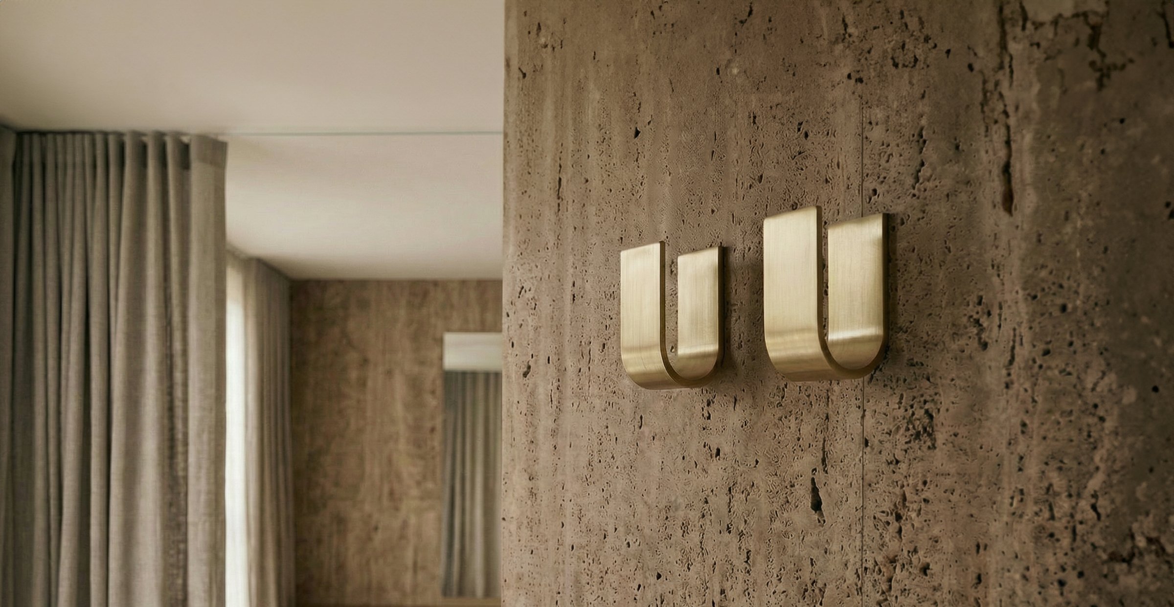 Custom brushed brass wall hooks designed for hospitality, retail, workplace, and residential environments, combining everyday utility with timeless craftsmanship.