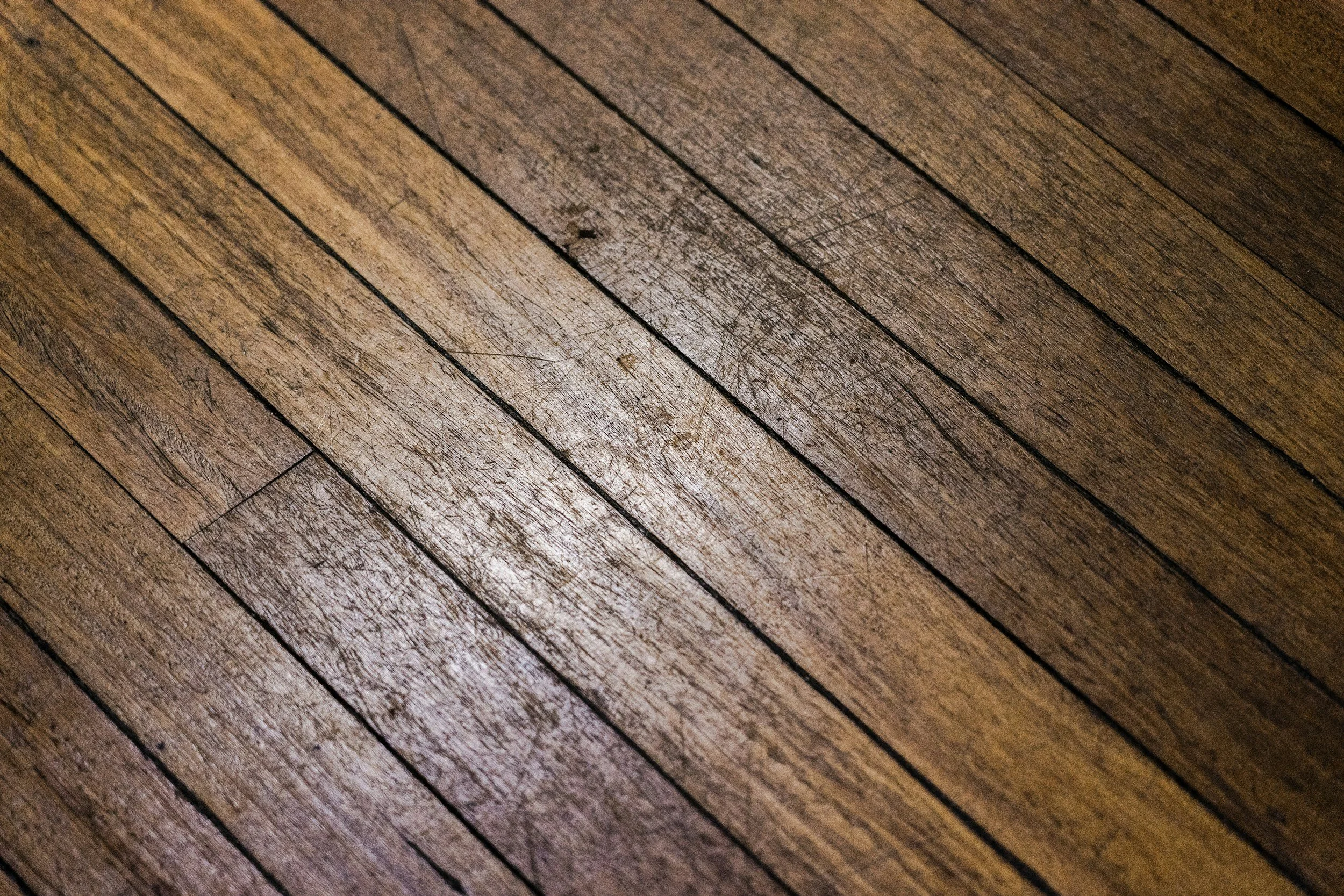 Close-up of a wooden floor with parallel planks.