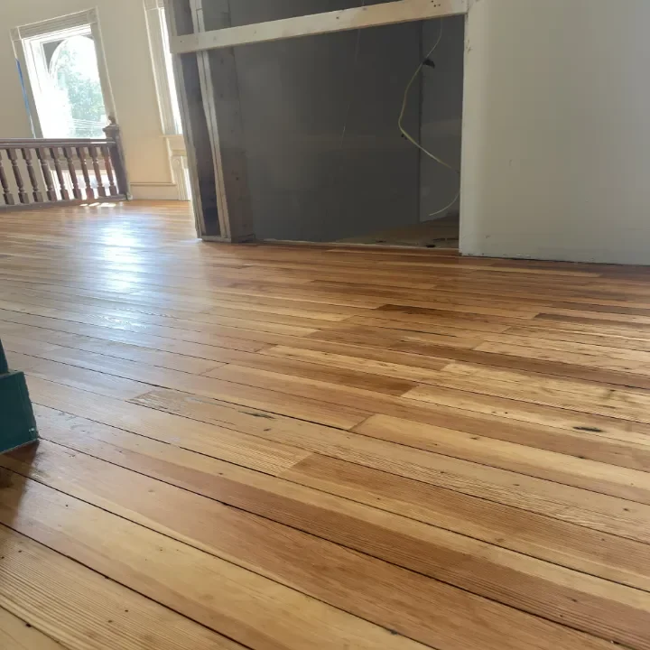 Recent hardwood floor restoration in a hotel with natural light.