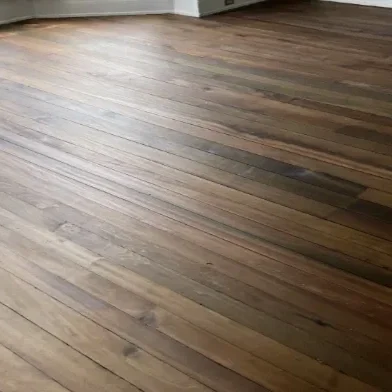 Close-up of a hardwood floor showing natural wood grain and variation in color.