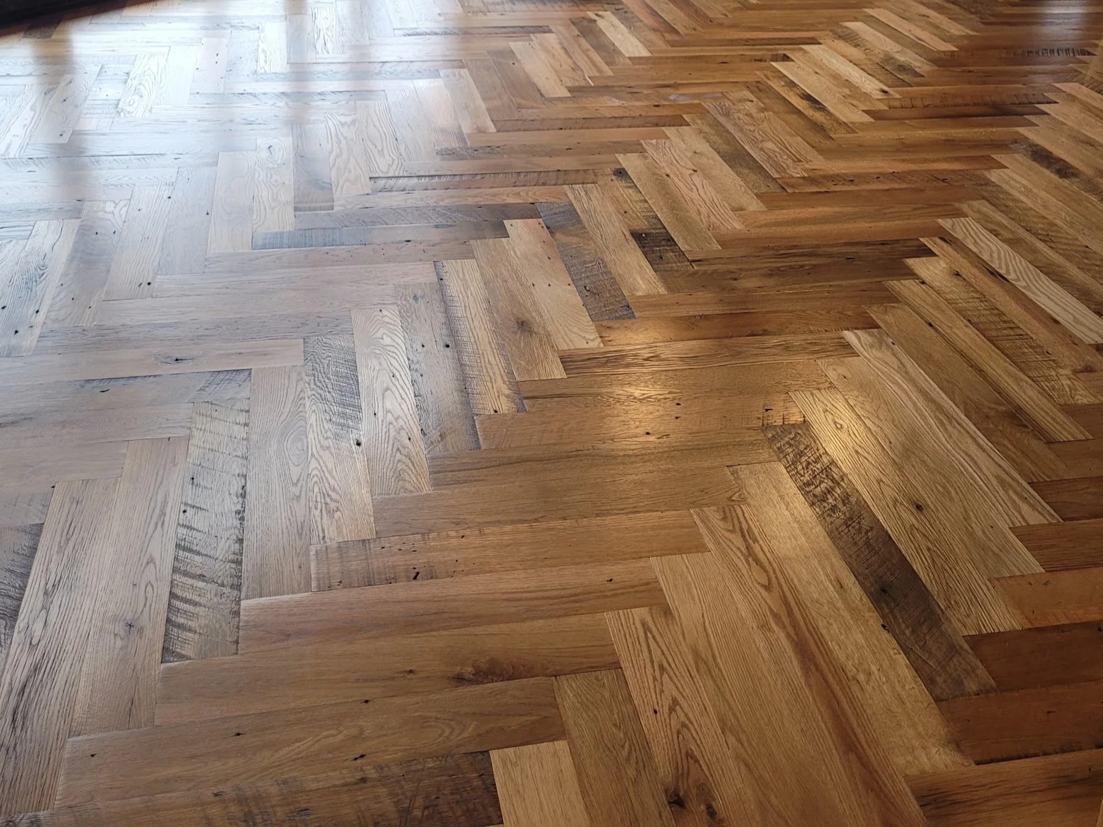 Wooden floor with a herringbone pattern.