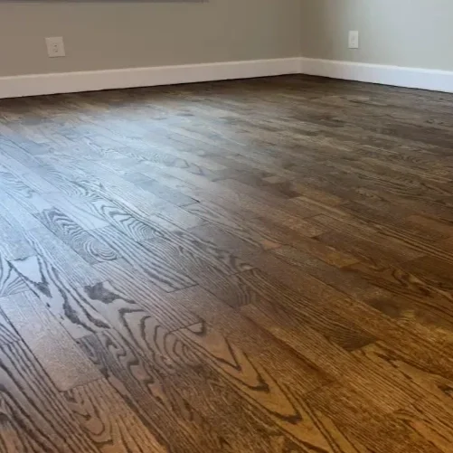 Empty room with hardwood floor and gray walls