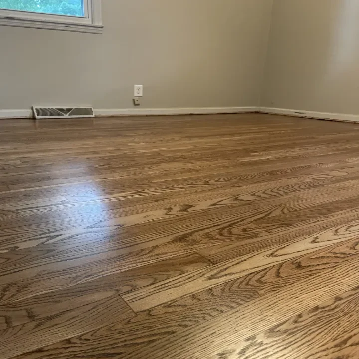 Empty room with hardwood flooring.