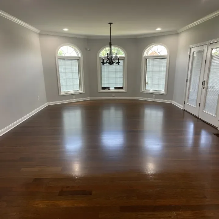 Empty living room with hardwood floors.