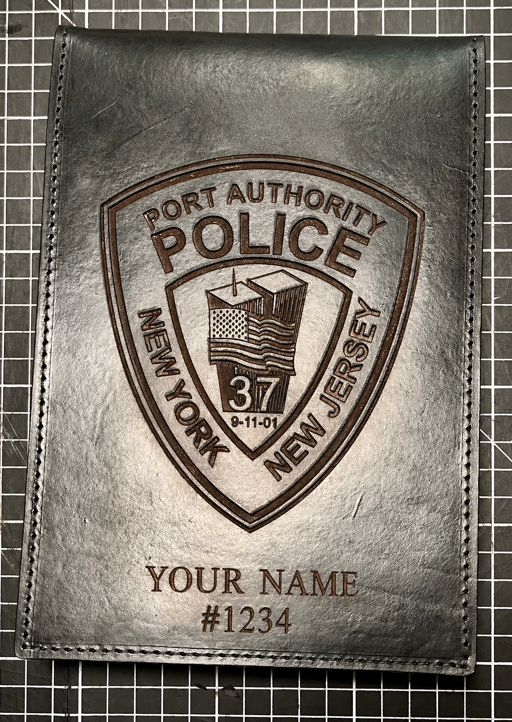 Leather wallet featuring the New Jersey Port Authority Police shield logo with staff's name and badge number.