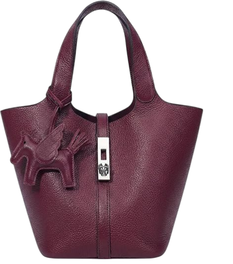 A purple leather handbag with a horse-shaped zipper pull on the front.