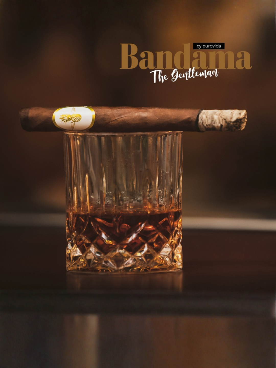 A glass of whiskey with a cigar resting on top, set against a dark background.