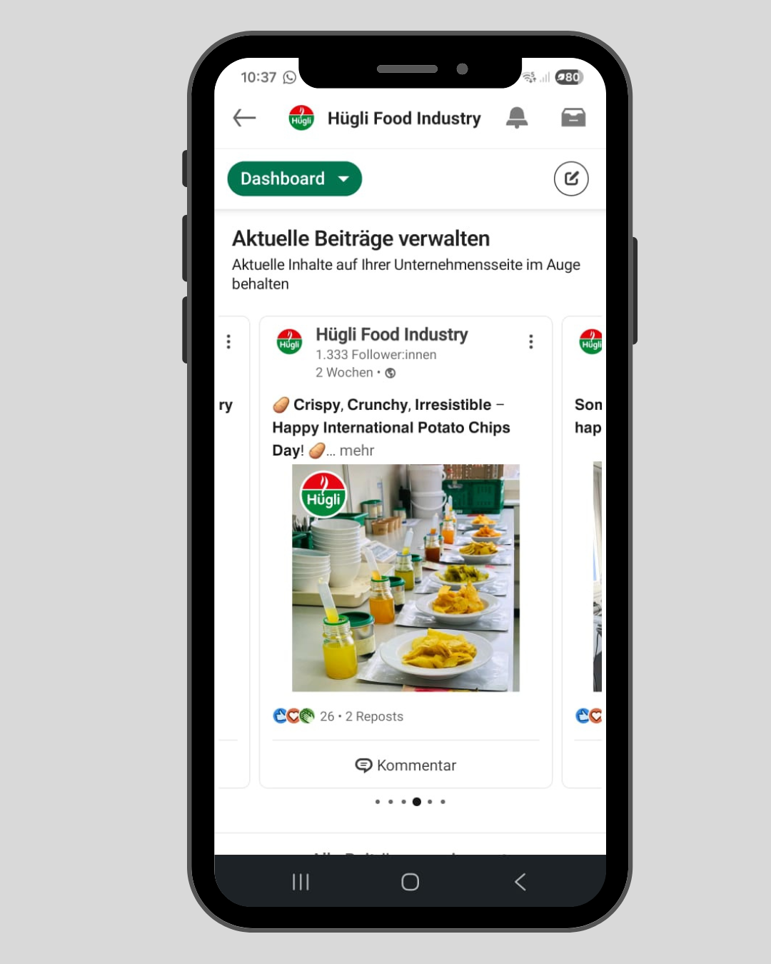 A smartphone screen displaying a social media post from Hügli Food Industry celebrating International Potato Chips Day, with a photo of potato chips and small jars of mustard or sauces on a table.