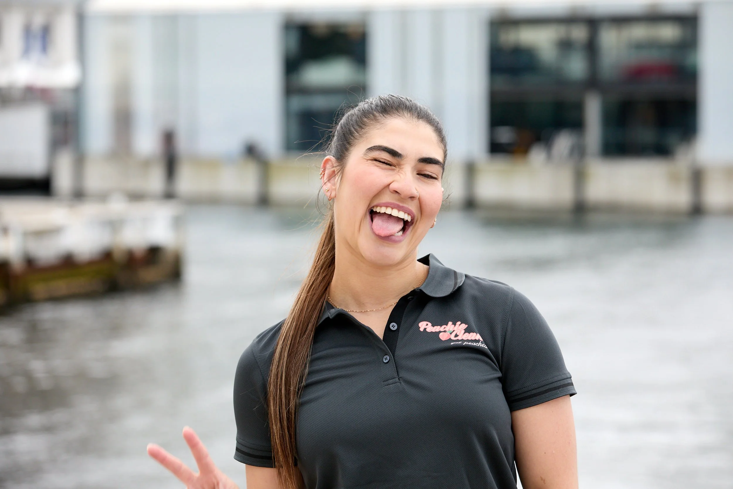 Peachie Clean supervisor smiling in uniform at Hobart waterfront, Tasmania
