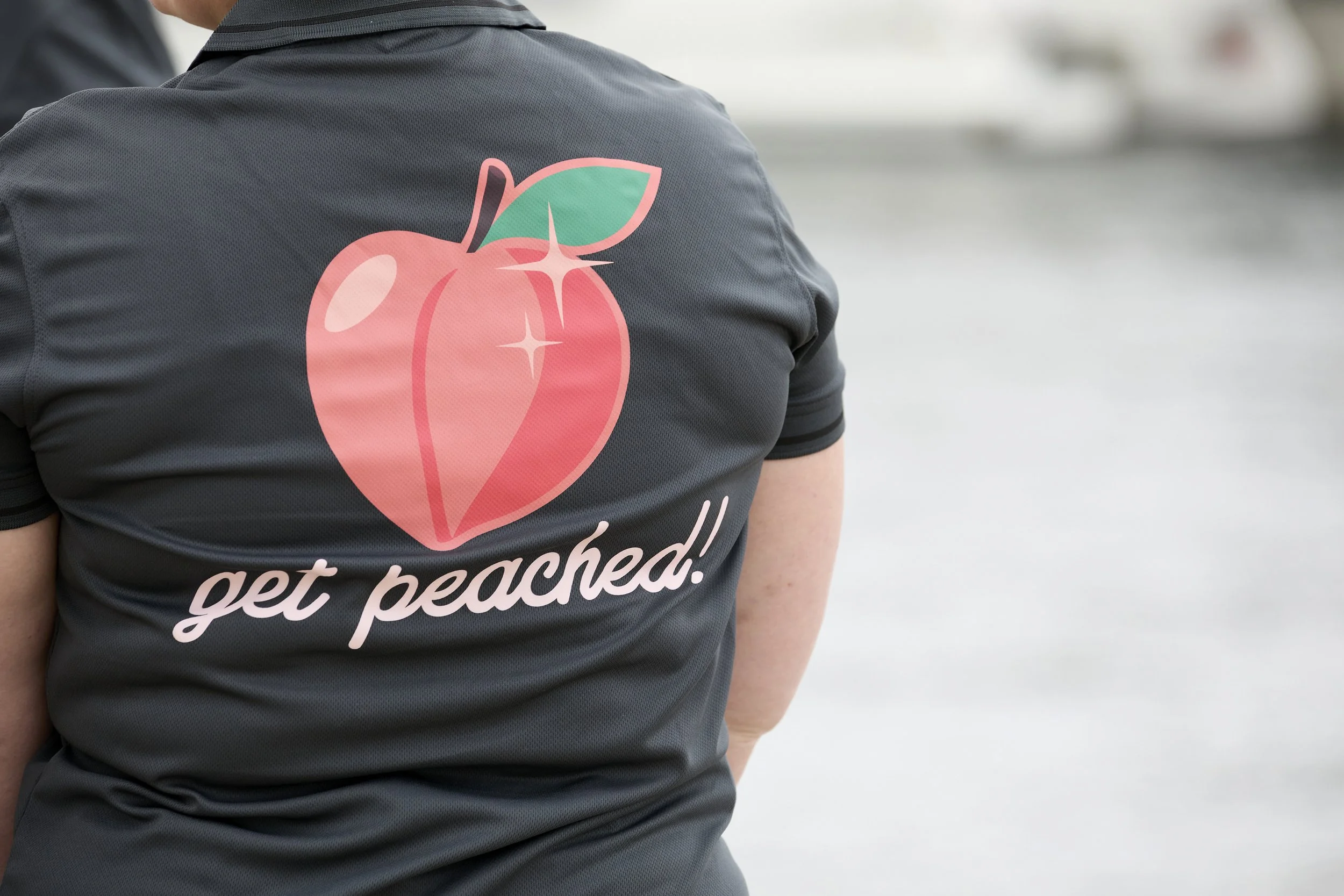 Peachie Clean team members in Hobart wearing branded uniforms with peach logo, representing professional commercial cleaning services