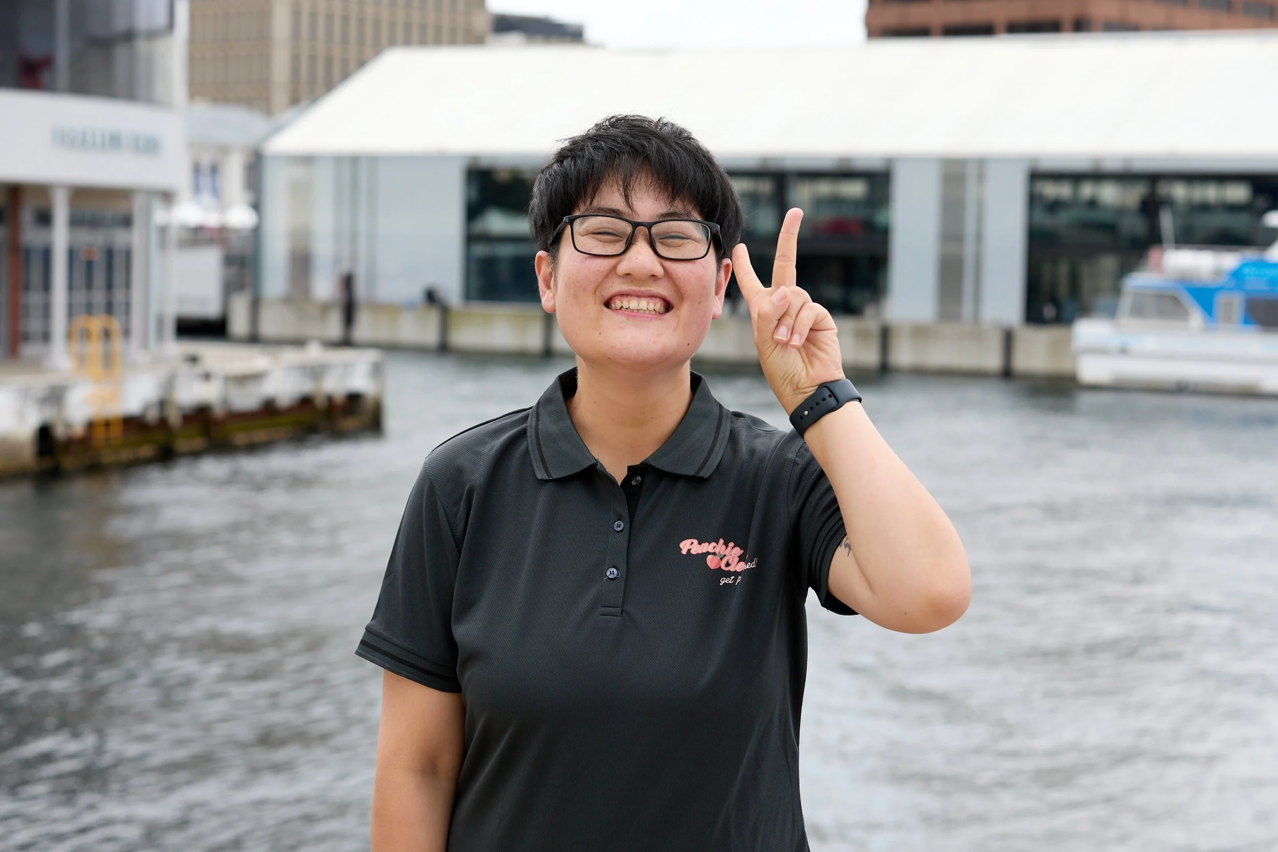 Peachie Clean supervisor smiling in uniform at Hobart waterfront, Tasmania