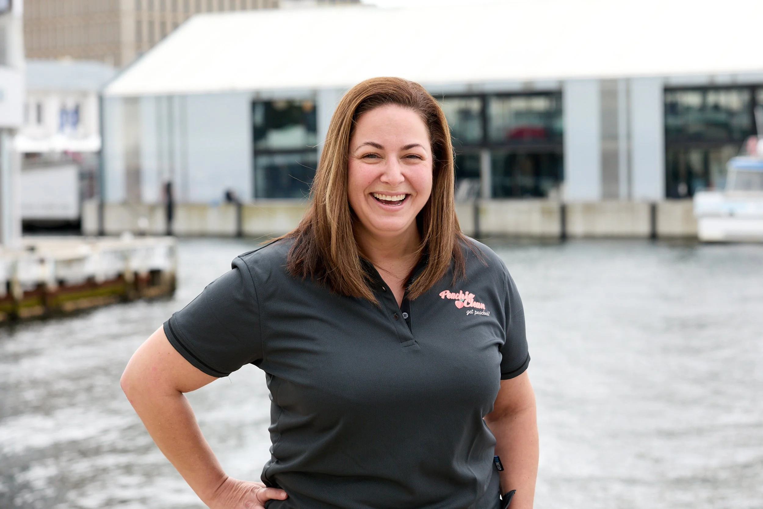 Peachie Clean COO smiling in uniform at Hobart waterfront, Tasmania