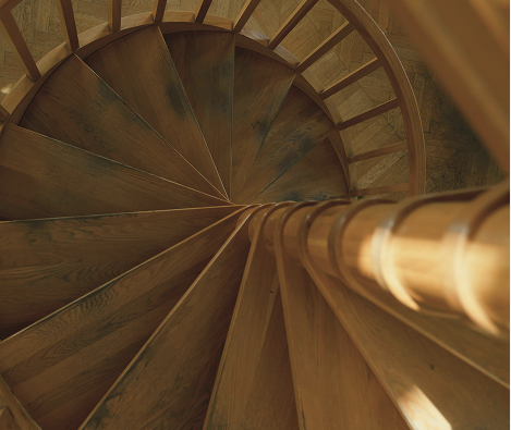 Top-down view of a wooden spiral staircase.