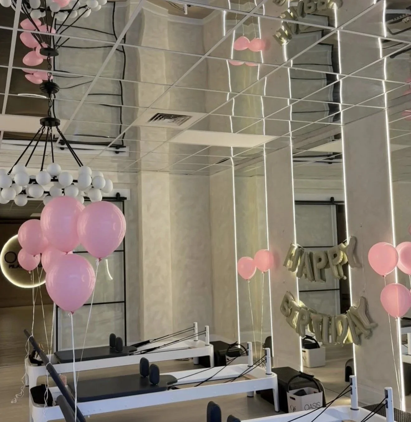 Decorated fitness studio with pink balloons, a