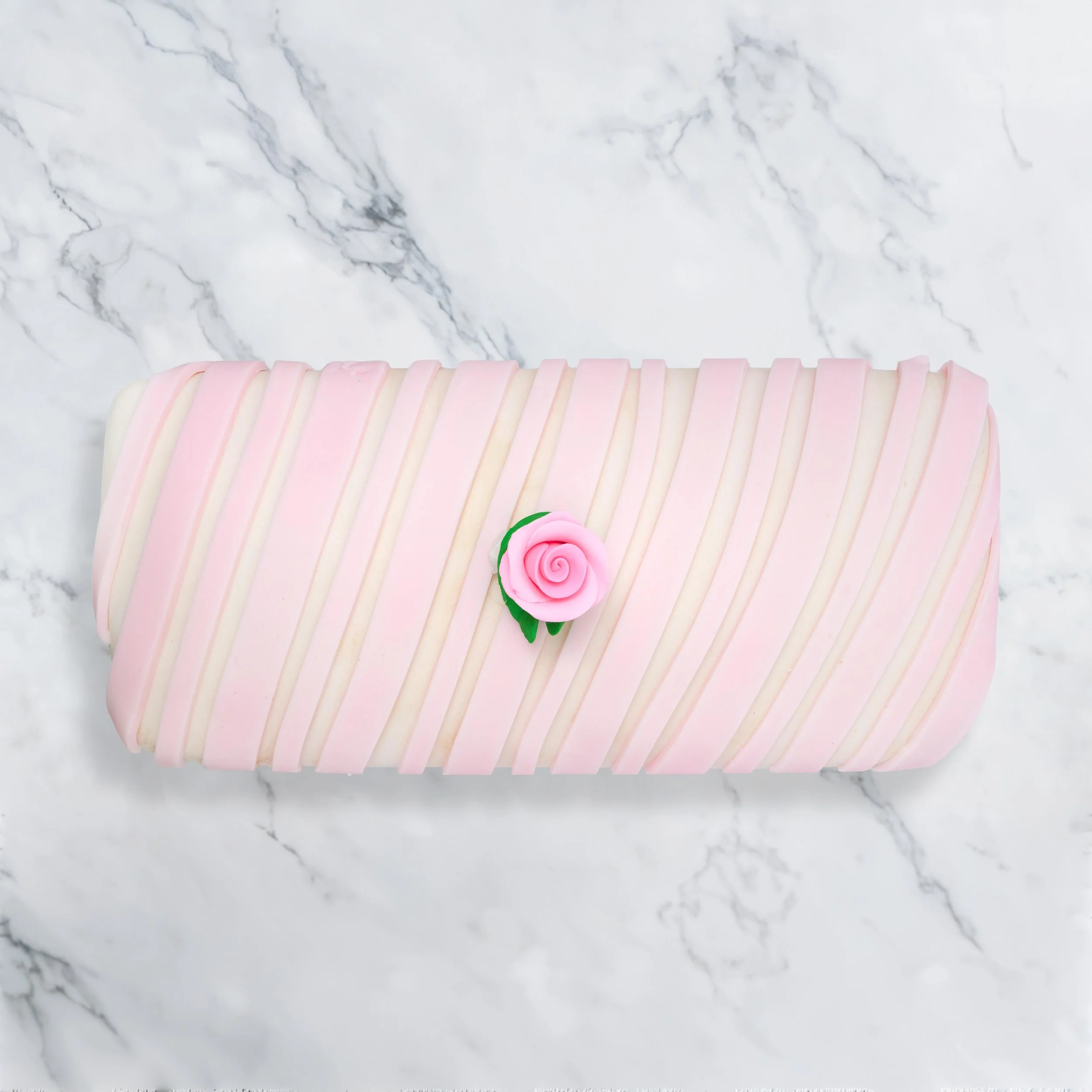 Large Bar Fruit Cake iced with white fondant , soft pink stripes and detailed with a pink sugar rose 