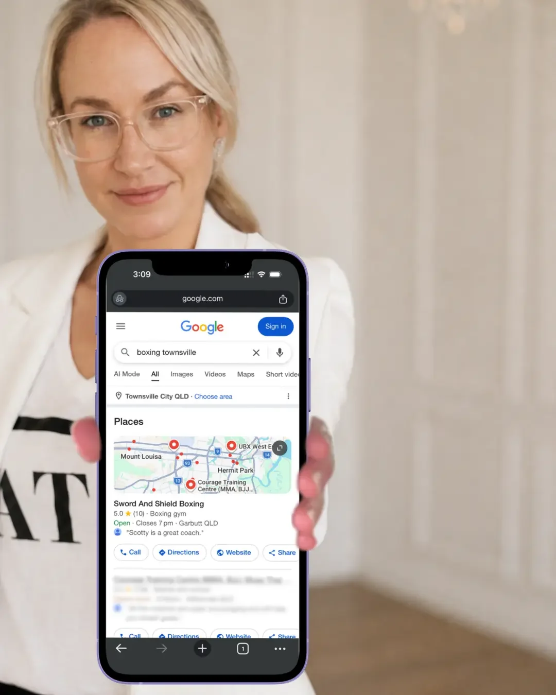 Google Business Profile optimisation in Townsville shown on smartphone held by local marketing consultant beside FAQs about Google listings, Google Maps visibility and local SEO