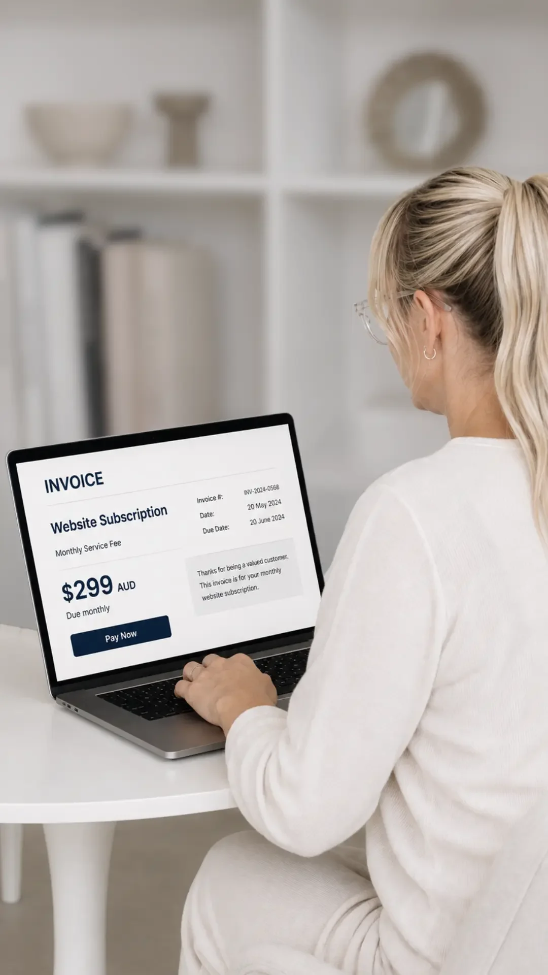 Business owner reviewing a monthly website subscription invoice while checking whether they own their business website