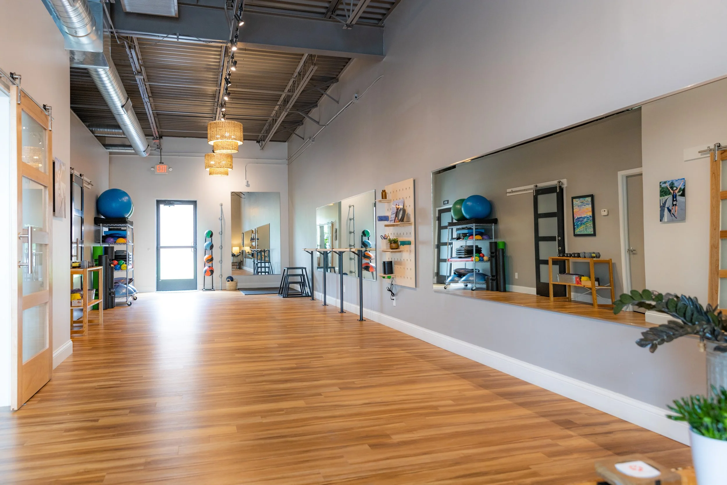 open gym space with mirrors and workout equipment