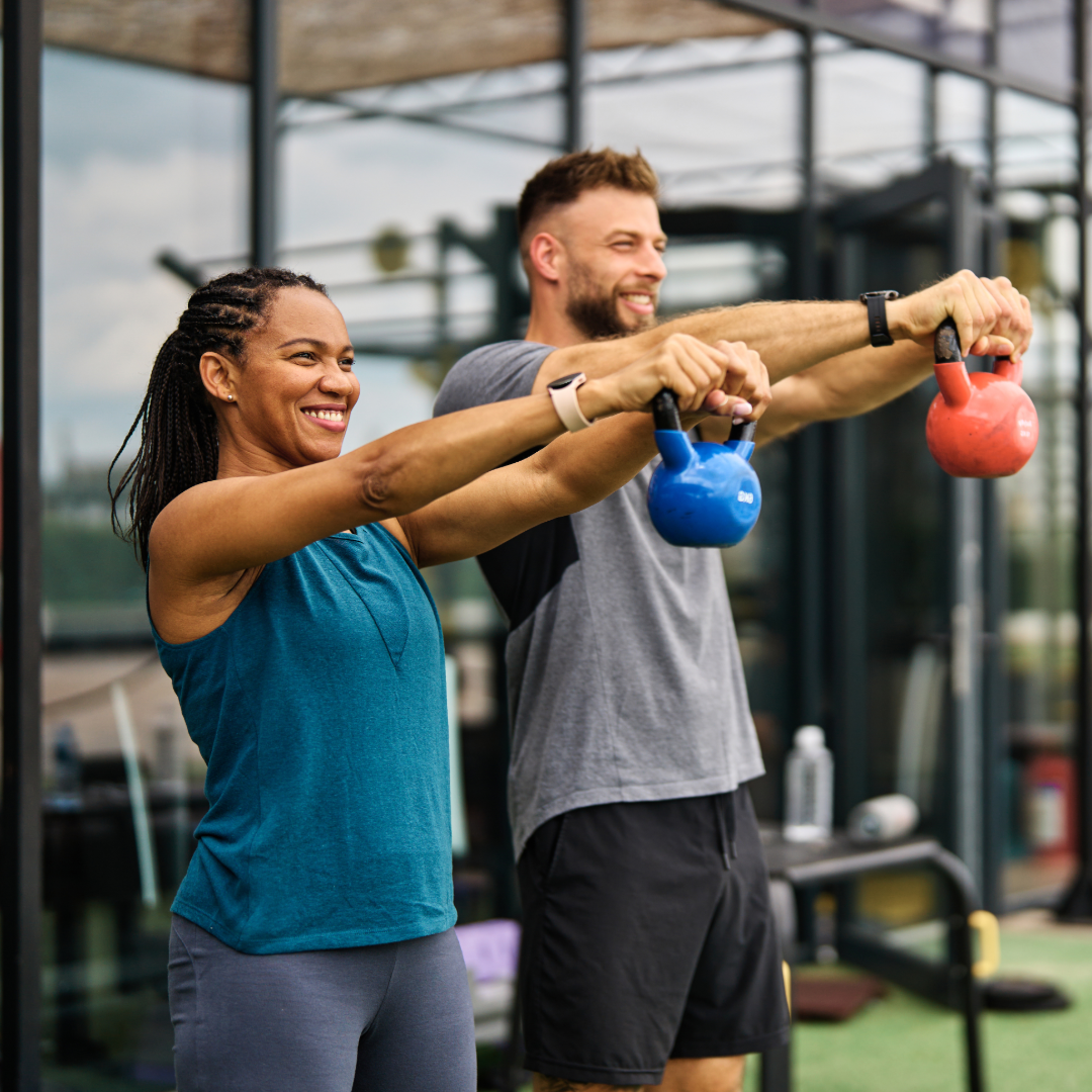 Woman and Man doing kettle bell swings