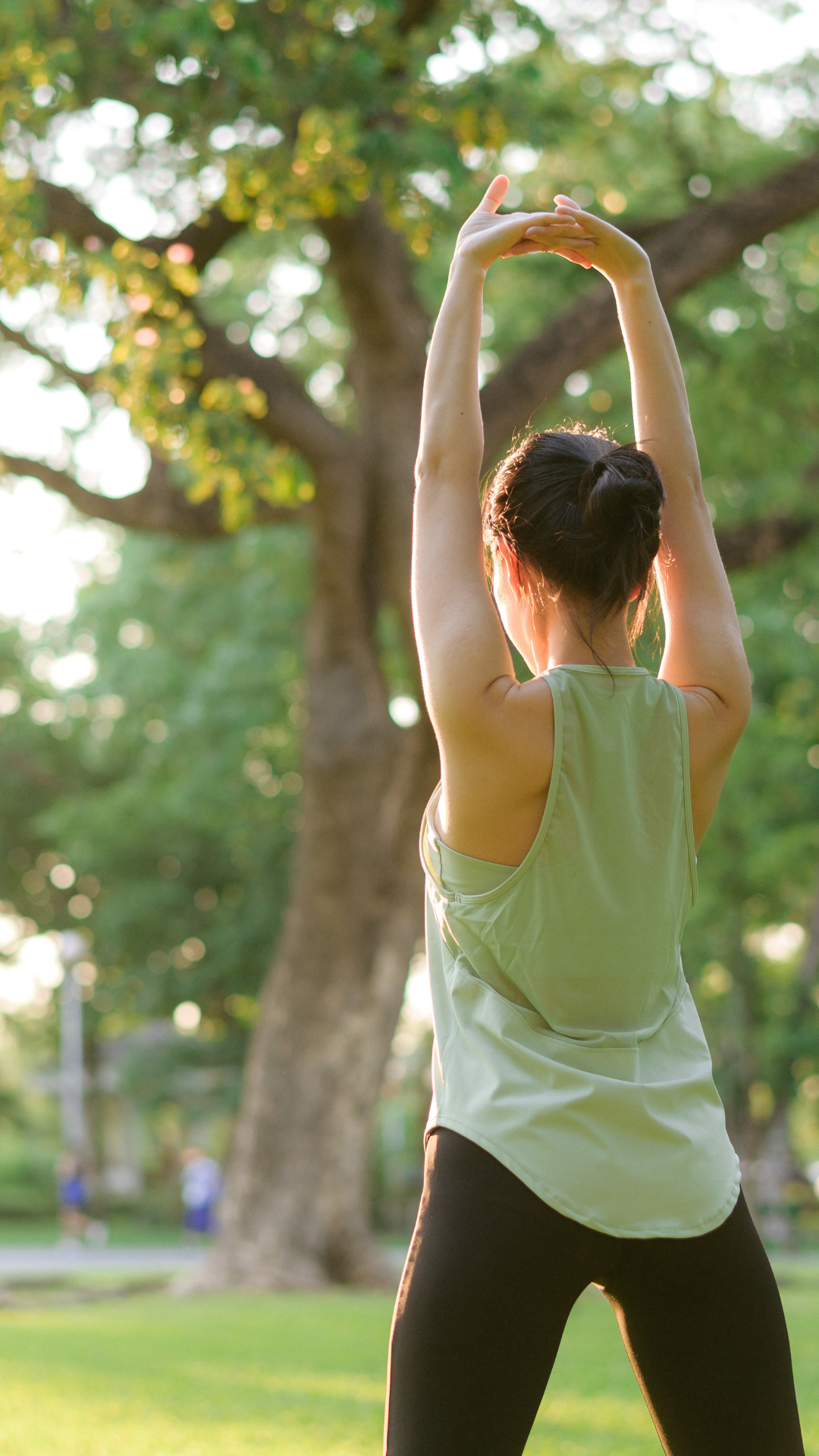 Woman stretching with arms overhead