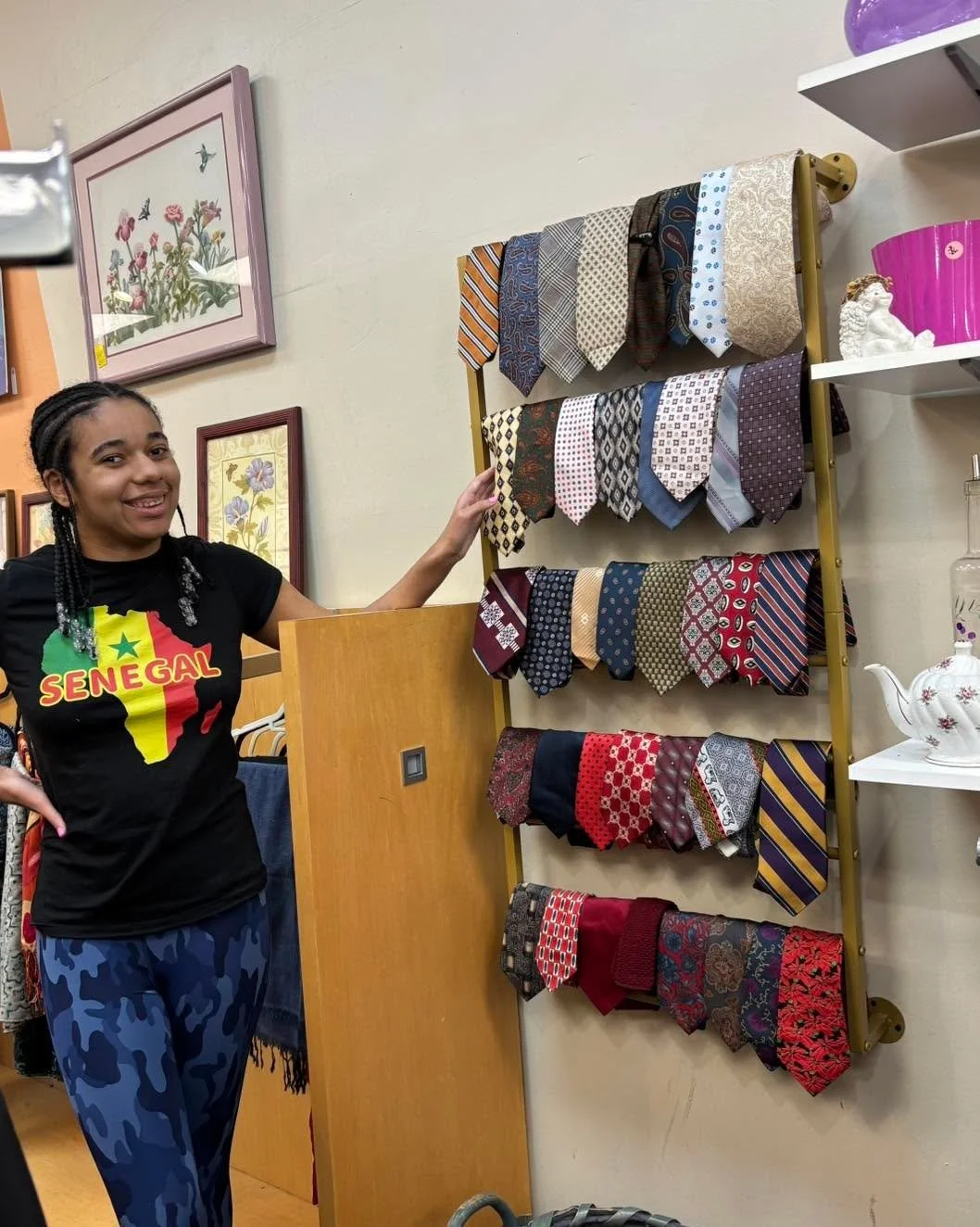 Zoe, Favarh Board of Education transition student, proudly shows off her organizational skills by straightening the necktie display at the Favarh Thrift Shop. 
You can purchase ties for $2.00 each and if you buy a suit, you get a tie for FREE!
#favar