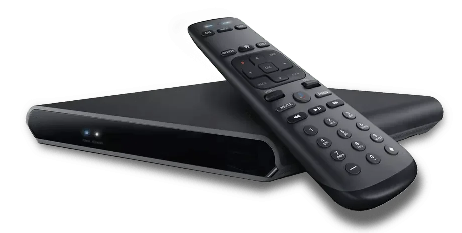 A black remote control resting on a black streaming device or set-top box.