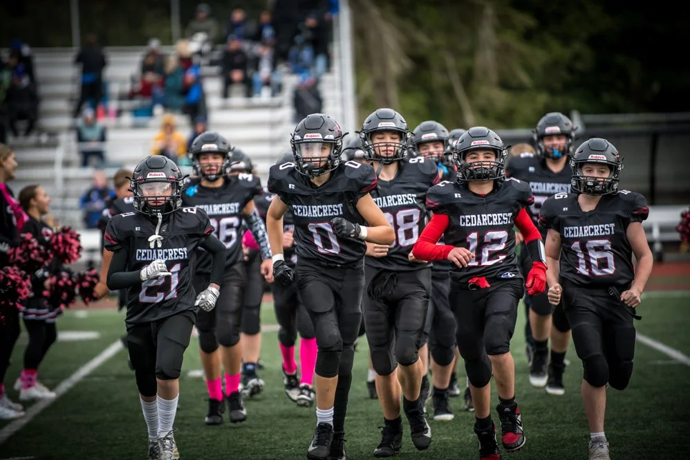 Red Wolves Football Players running on to the field