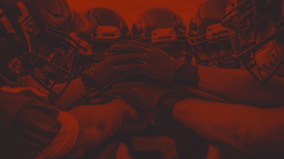 Football players in huddle