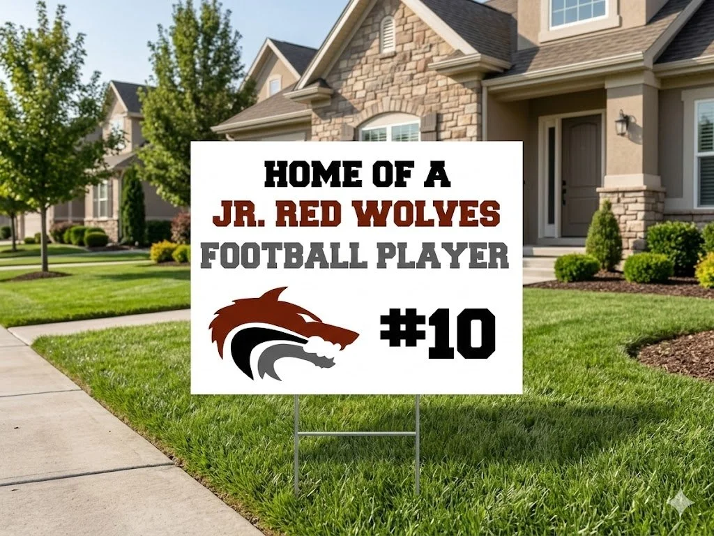 A yard sign in front of a house.