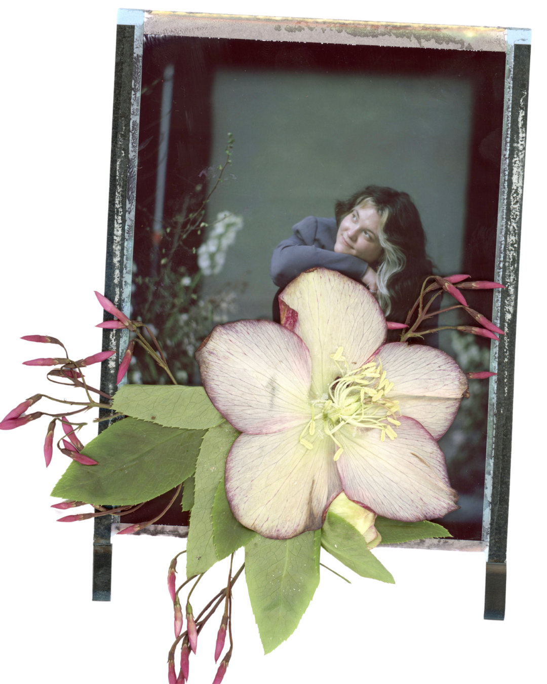 A woman resting her head on her arm inside a mirror, surrounded by flowering plants and a large pale pink and cream-colored flower in the foreground.