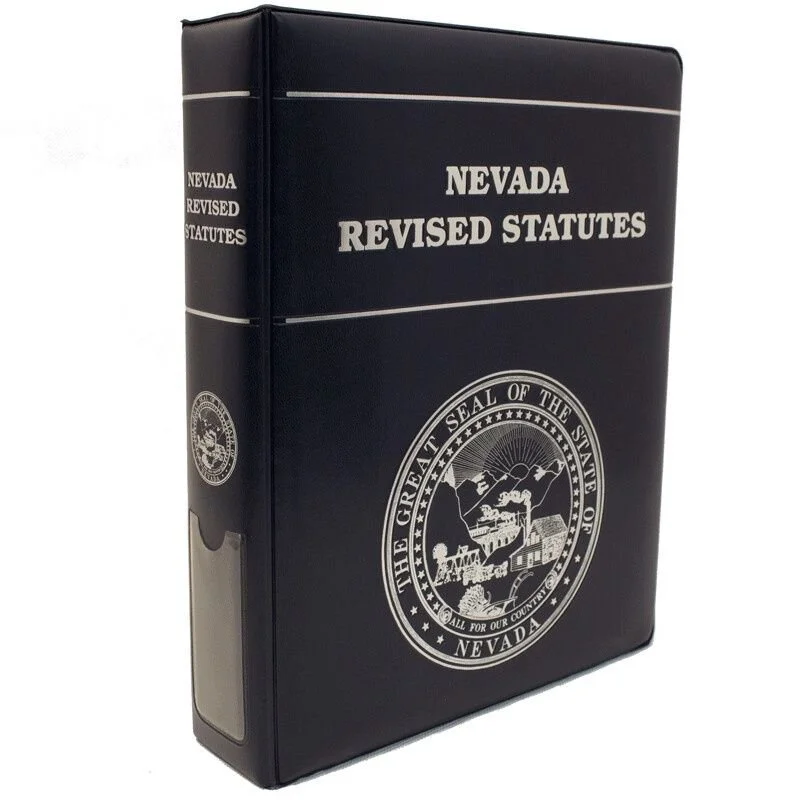 A black binder with silver text and seal, titled Nevada Revised Statutes, displaying the Great Seal of the State of Nevada.