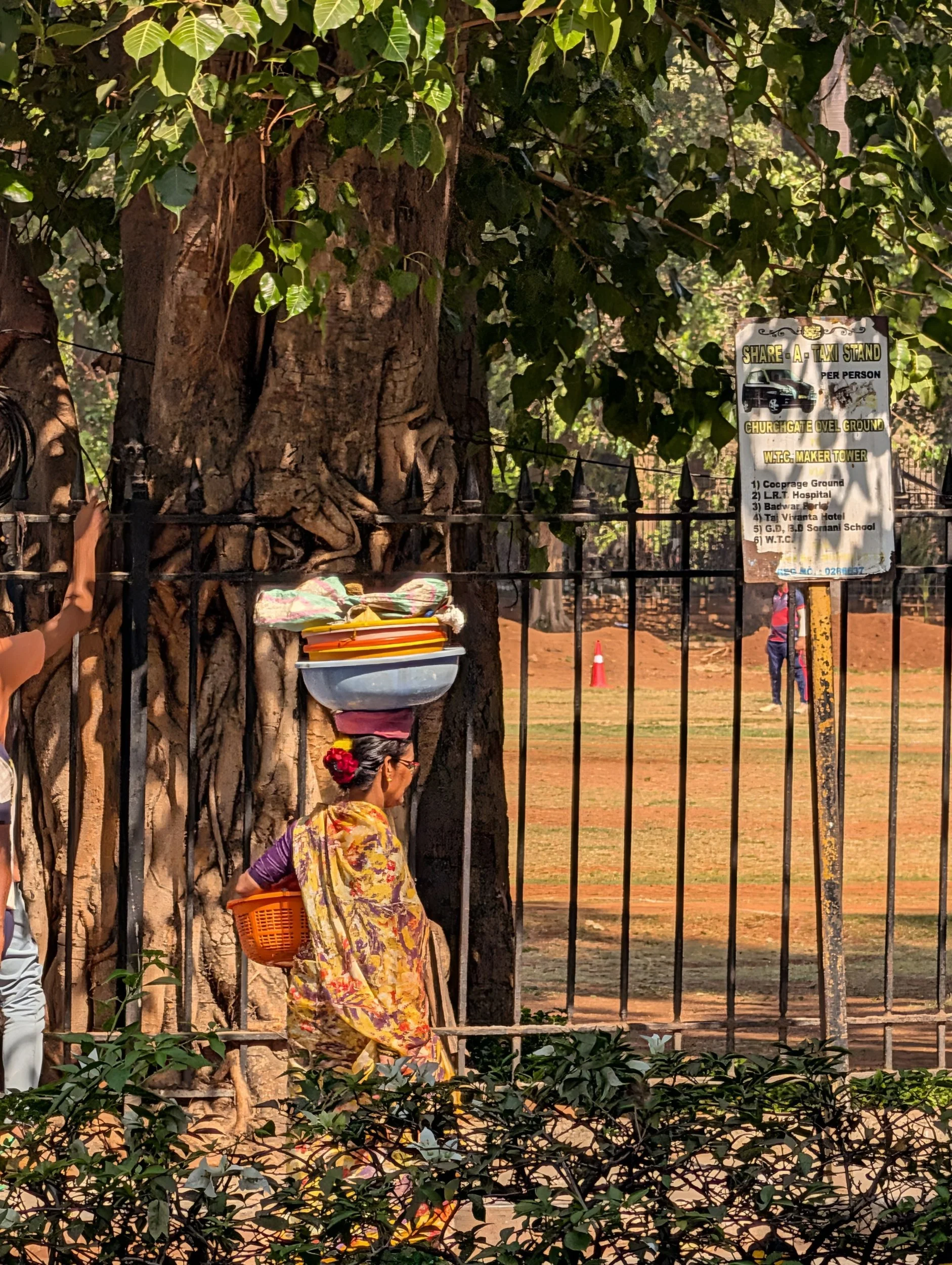 A woman carrying a perfectly balanced item on her head, symbolising cross border hands on, practical  execution work  Daksha Consulting does