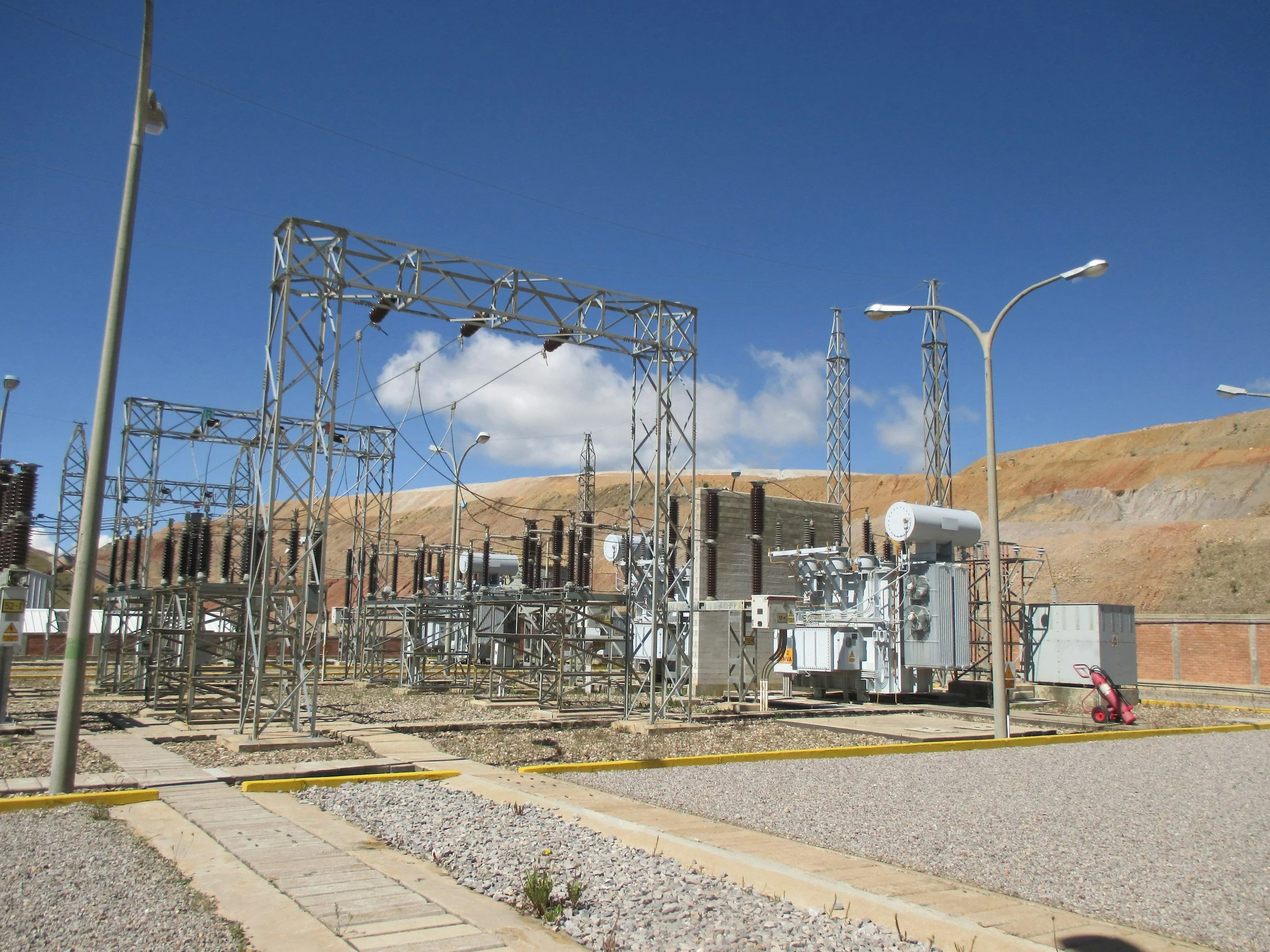 Electrical substation and power grid infrastructure under a clear blue sky