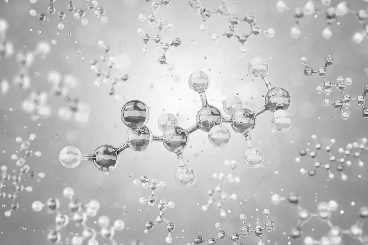 A grayscale digital illustration of molecules with atoms connected by bonds, floating in space.
