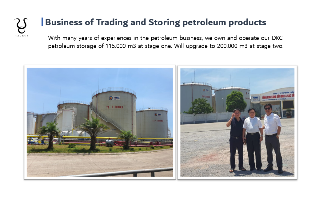 Petroleum storage tanks at a petroleum company, with three men standing in front of the tanks, some trees, and a sign in Vietnamese.