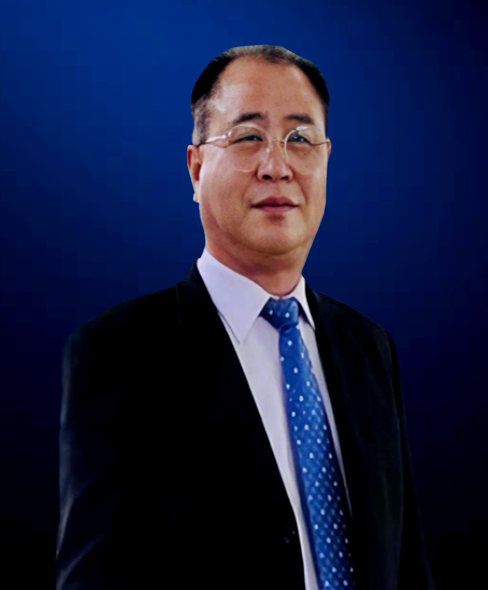 A man in a suit with glasses, wearing a white shirt and blue tie, standing against a dark blue background.